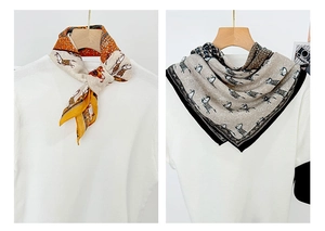 Detail of vintage horse print square scarves in orange and taupe on white t-shirts