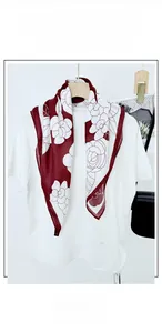 Detail view of burgundy floral square scarf with large white camellia prints on cotton-linen