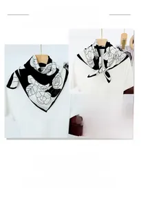 Elegant black and white camellia floral print silk scarf styled on a white t-shirt