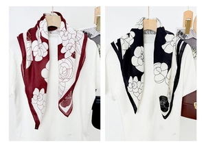 Detail of camellia floral print scarves in burgundy and black on white background