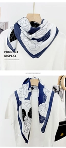 Detailed view of floral imitation cashmere scarf with blue and white rose patterns