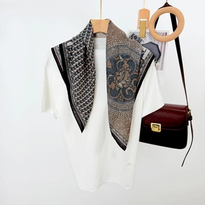 Vintage horse and floral print square scarf draped on a white sweater with wooden hanger