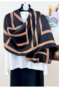 Detail of soft linen scarf featuring abstract geometric pattern in black and tan