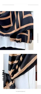 Detailed view of the black and camel geometric pattern on imitation cashmere scarf