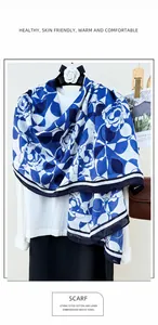Detail of blue and white cotton linen scarf with rose pattern and striped border edges