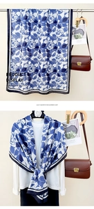 Detail of blue and white floral imitation cashmere scarf draped over a white shirt