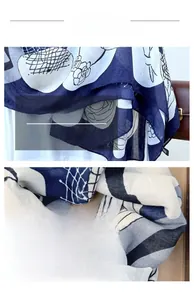 Detail of floral print scarf showing refined edge stitching and soft cotton linen fabric