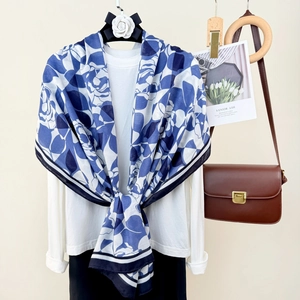 Blue and white floral print cotton linen scarf styled with a white top and brown handbag