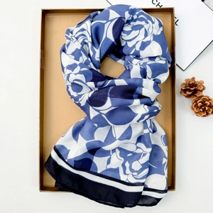 Blue and white floral cotton linen scarf presented in a gift box with a pine cone