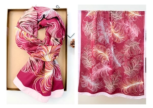 Detailed feather pattern on a lightweight rose red and pink linen cotton scarf