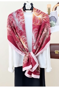 Detail of red feather print cotton linen scarf draped over a white elegant shirt