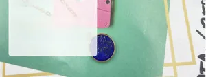 Close-up of a round lapis lazuli pendant featuring gold flecks and a gold-plated bezel