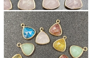 Macro view of multi-color faceted teardrop charms with gold edging for jewelry making