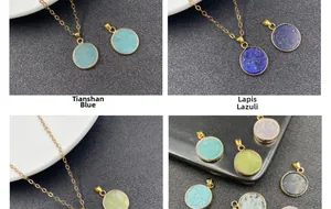 Detailed view of various round natural stone pendants with elegant gold plated edges