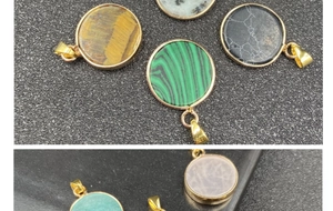 Flat lay of multiple natural stone round pendants with elegant gold plated metal edging