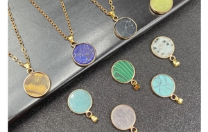 Close-up of gold-plated circular natural stone pendants in various gem colors