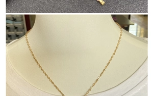 Detail of thin gold-plated O-chain necklace with lobster clasp on mannequin