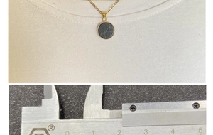 Detail view of round black marble pendant necklace with gold trim and size measurement