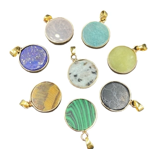 Set of eight assorted natural stone round pendants with gold-plated edges on white backdrop