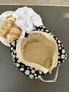 Large daisy print toiletry bag with zipper closure and portable handle for travel