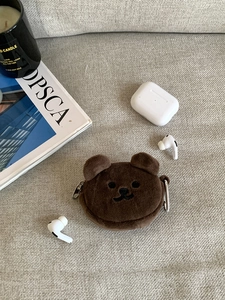 Close-up of brown plush bear coin purse with embroidery detail and metal carabiner hook