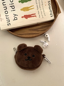 Close-up of brown plush bear storage pouch with embroidery and dual metal hanging clips