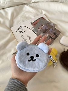 Detailed view of light blue plush bear pouch with metal carabiner and zipper closure