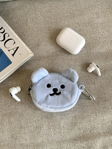 Close-up of light blue plush bear coin purse with fine embroidery and metal clip hook