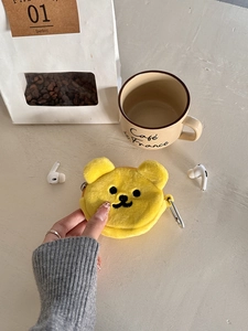 Detail of yellow plush bear coin purse with metal zipper and silver carabiner clip
