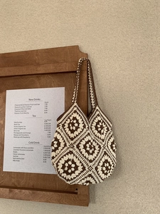 Handmade crochet tote bag with brown floral patterns for bohemian summer vacations