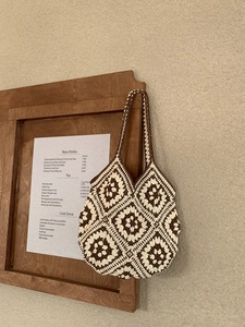 Close-up of handmade crochet tote bag featuring vintage floral granny square patterns