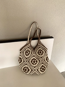 Detail of handmade crochet tote bag with brown and beige floral granny square pattern