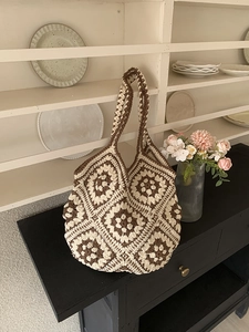 Detail of crochet tote bag with brown and beige granny square floral patterns
