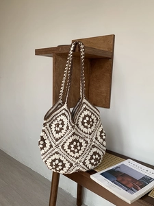 Close-up of handmade crochet tote bag featuring vintage brown and white granny square pattern