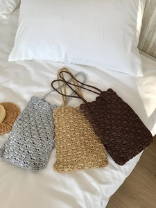 Detailed knit texture of handmade crochet shoulder bags in silver, gold, and brown tones