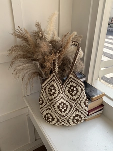 Close-up of bohemian crochet tote bag featuring vintage brown and beige floral granny squares
