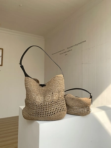 Detailed comparison of large woven tote and small clutch with black leather straps