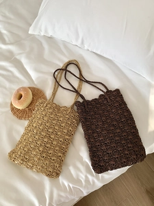 Detail of hand-woven crochet shoulder bags in beige and brown with shell texture