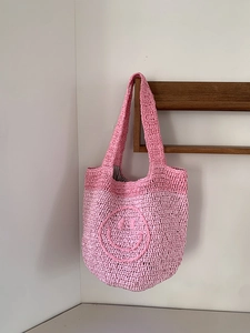 Pink gradient hand-crocheted mini handbag with a cute woven smiley face design