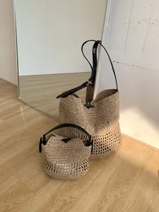 Detail of hand-woven straw beach bags with leather straps and retro horn buckles