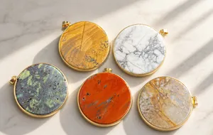 Detailed view of various round natural stone pendants with elegant gold metal edging