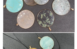Detailed view of natural round stone pendants with gold plating and black cords