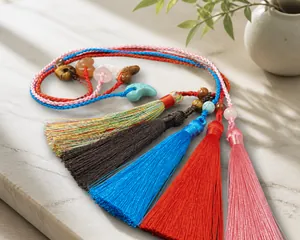 Macro shot of colorful handmade magatama tassels with gemstones and woven cords