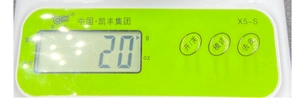 Detail of green kitchen scale control panel with LCD display and X5-S model buttons