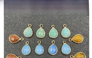 Macro view of teardrop faceted gemstones with gold plated edges for DIY jewelry making