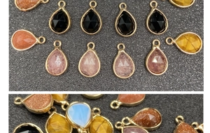 Macro detail of teardrop gemstone pendants with gold metal frames and faceted surfaces