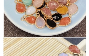 Macro detail of pear-shaped gemstone pendants with gold metal edging for DIY jewelry making