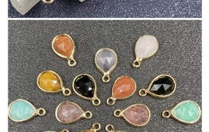Macro detail of teardrop faceted gemstones with gold plated edges for DIY jewelry making