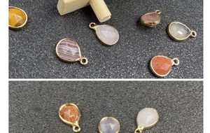 Detail of teardrop faceted gemstones with gold-plated bezel and hanging loops