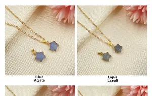 Macro detail of blue chalcedony and labradorite star pendants on gold thin chains